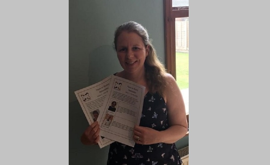 Beth holding the newsletters