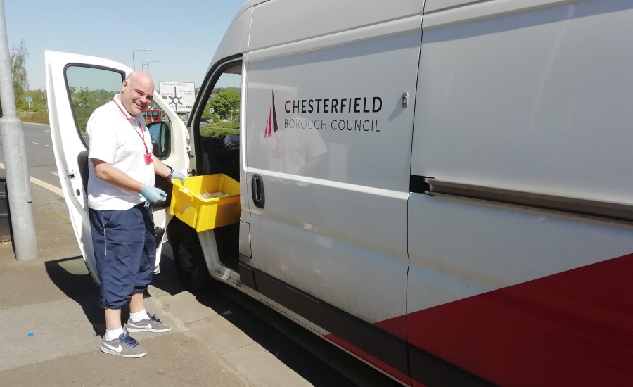 man putting a box in a Chesterfield Borough Council branded van