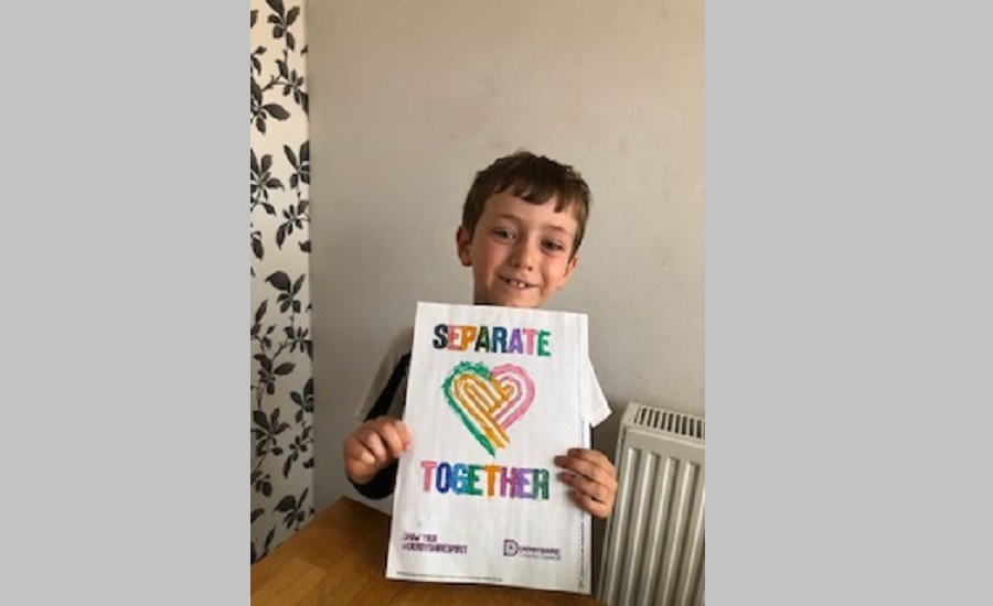 William holding a separate together poster