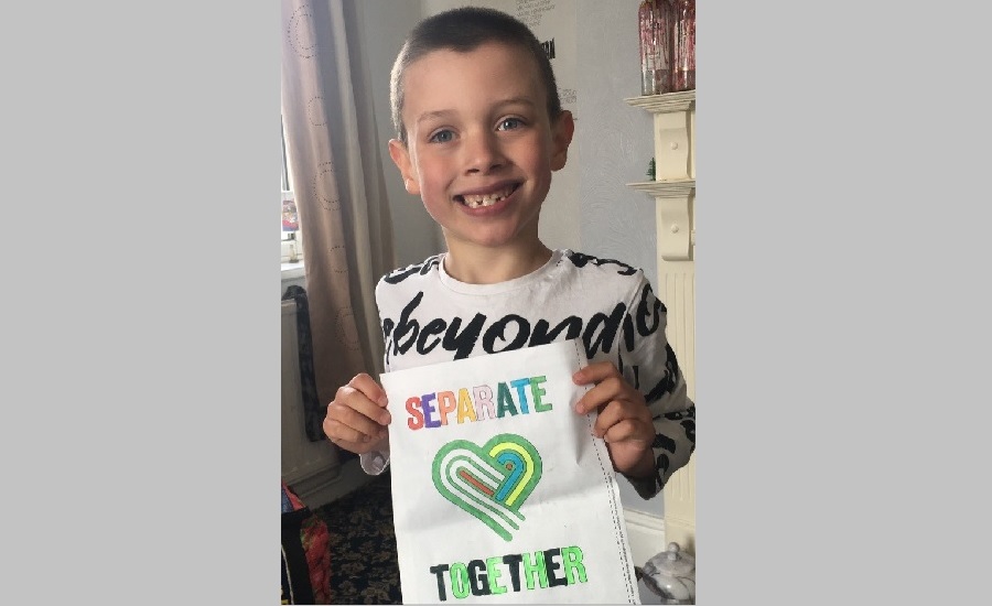 Frazer holding a seperate together poster